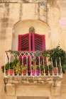 Mdina, Malta. Beautiful rose colored shutters on a window found on the streets of Mdina. Art Print
